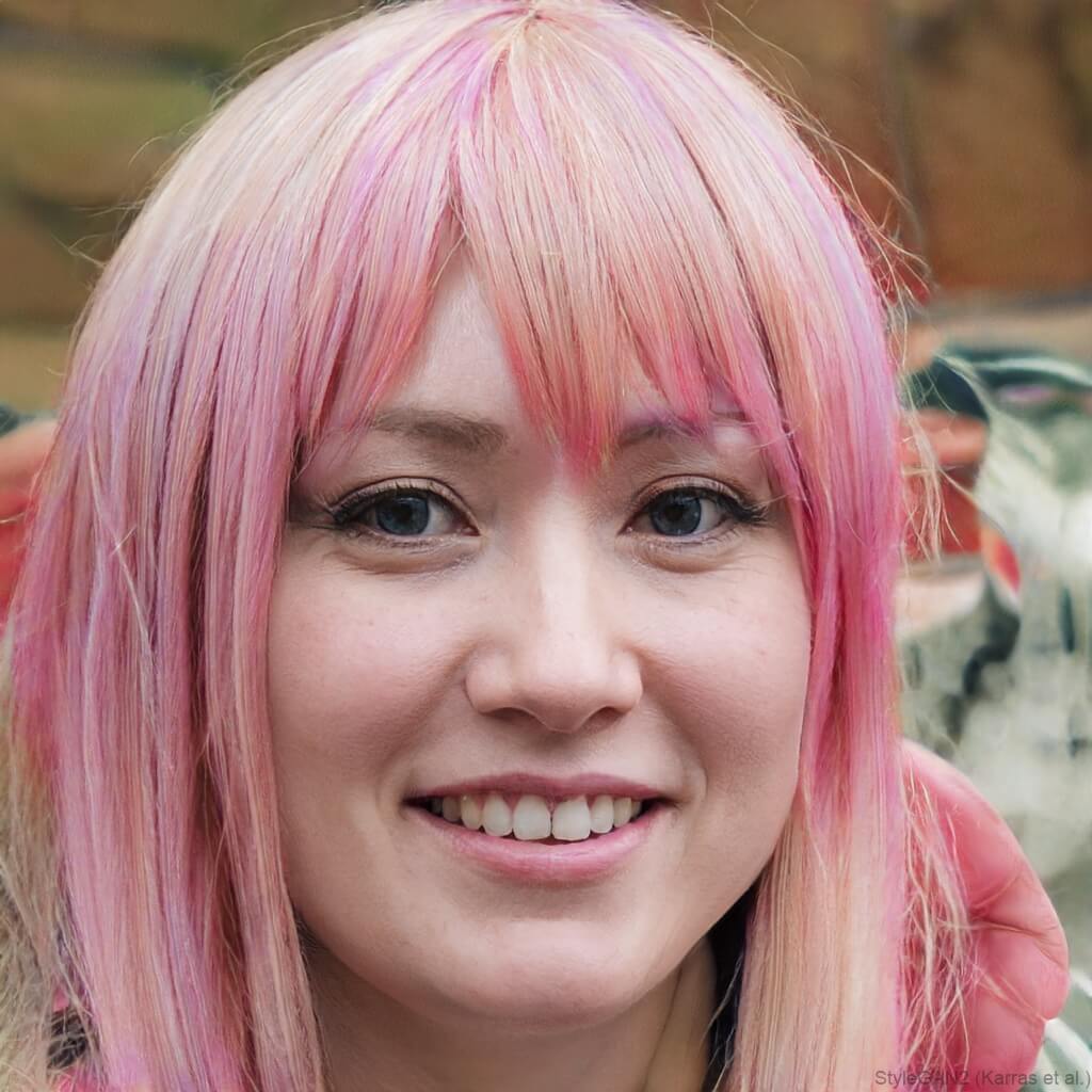 white woman with pink hair blue eyes smiling